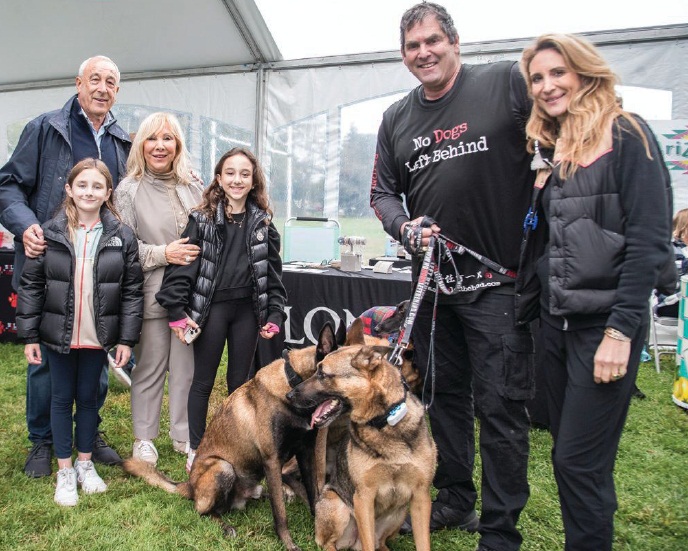 Candy Udell and family with No Dogs Left Behind founder Jeffery Beri at an adoption event in East Hampton PHOTO COURTESY OF SUBJECTS