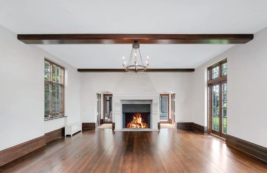 An oversized fireplace is the focal point of the elegant formal living room. PHOTO BY MIKE AGHACHI/LUXQUE MEDIA