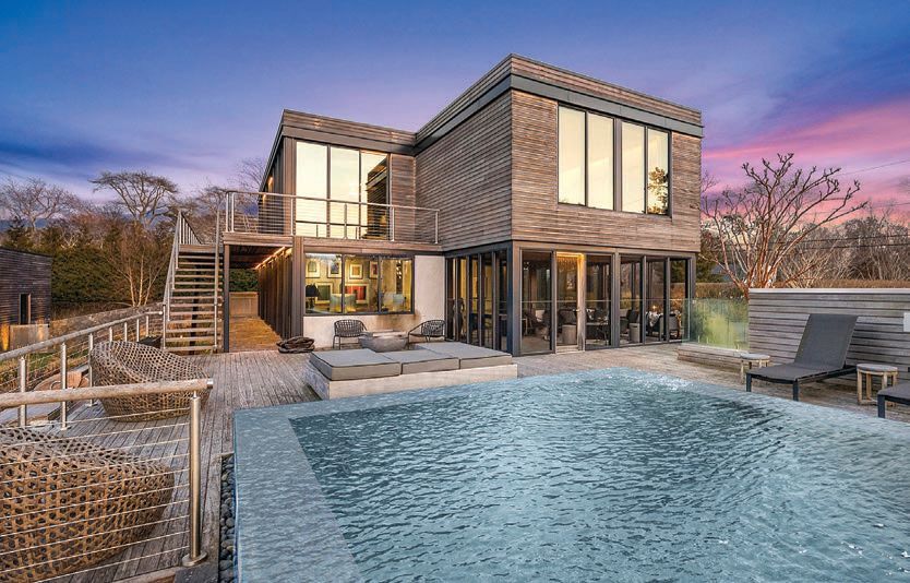 the home’s wood, stone, glass and steel exterior and the heated infinity pool PHOTO BY RISE MEDIA/COURTESY OF DOUGLAS ELLIMAN