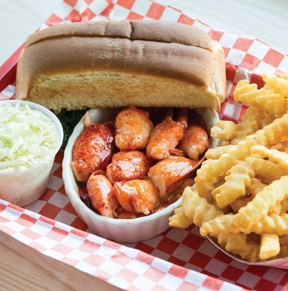 Warm lobster roll with bun and crinkle-cut french fries PHOTO BY PAUL BROOKE JR.