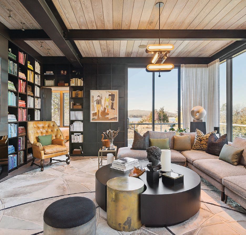 the living room is complete with a bookcase, a gas fireplace,  and more PHOTO BY RISE MEDIA/COURTESY OF DOUGLAS ELLIMAN