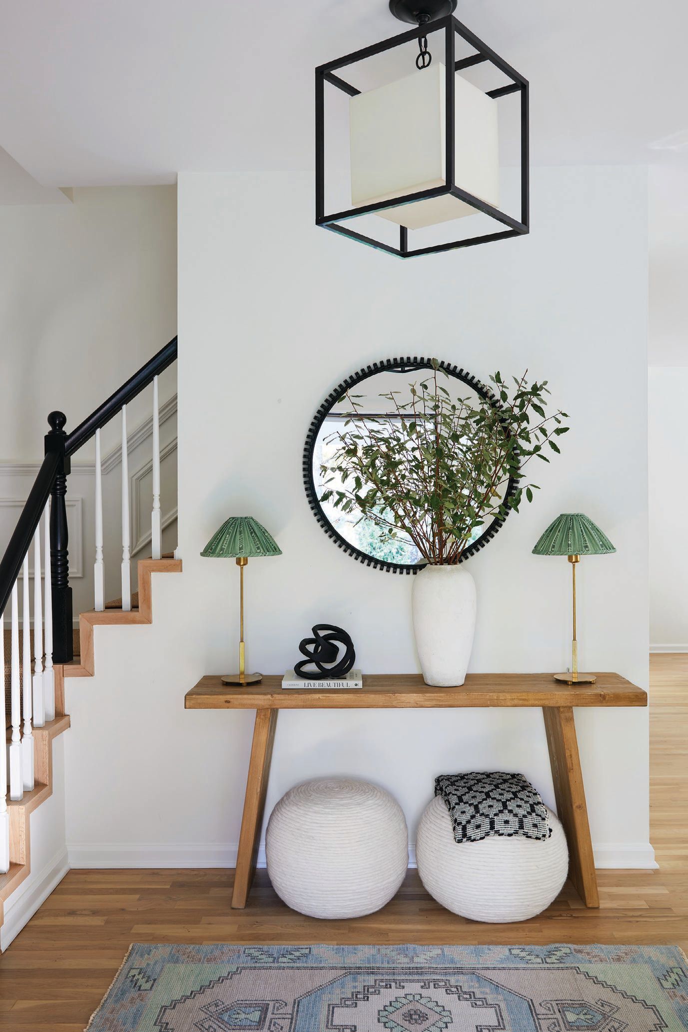 The entryway greets guests with an open floor plan, fit with a stunning RH console, vibrant lampshades, an eye-catching mirror and much, much more.  PHOTOGRAPHED BY KIRSTEN FRANCIS